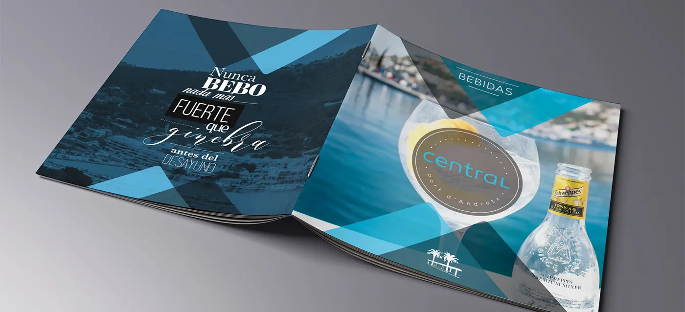 Carta de bebidas con copa de cóctel y botella de Schweppes junto al mar