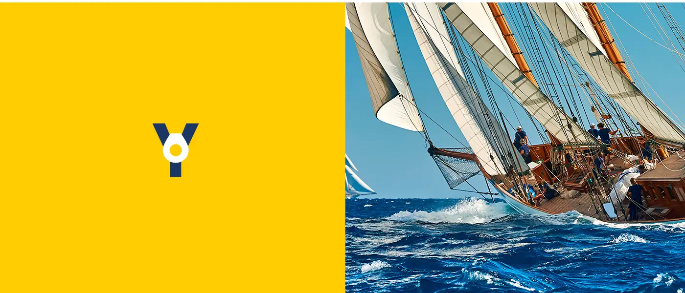 El monograma junto a la fotografía de un velero clásico