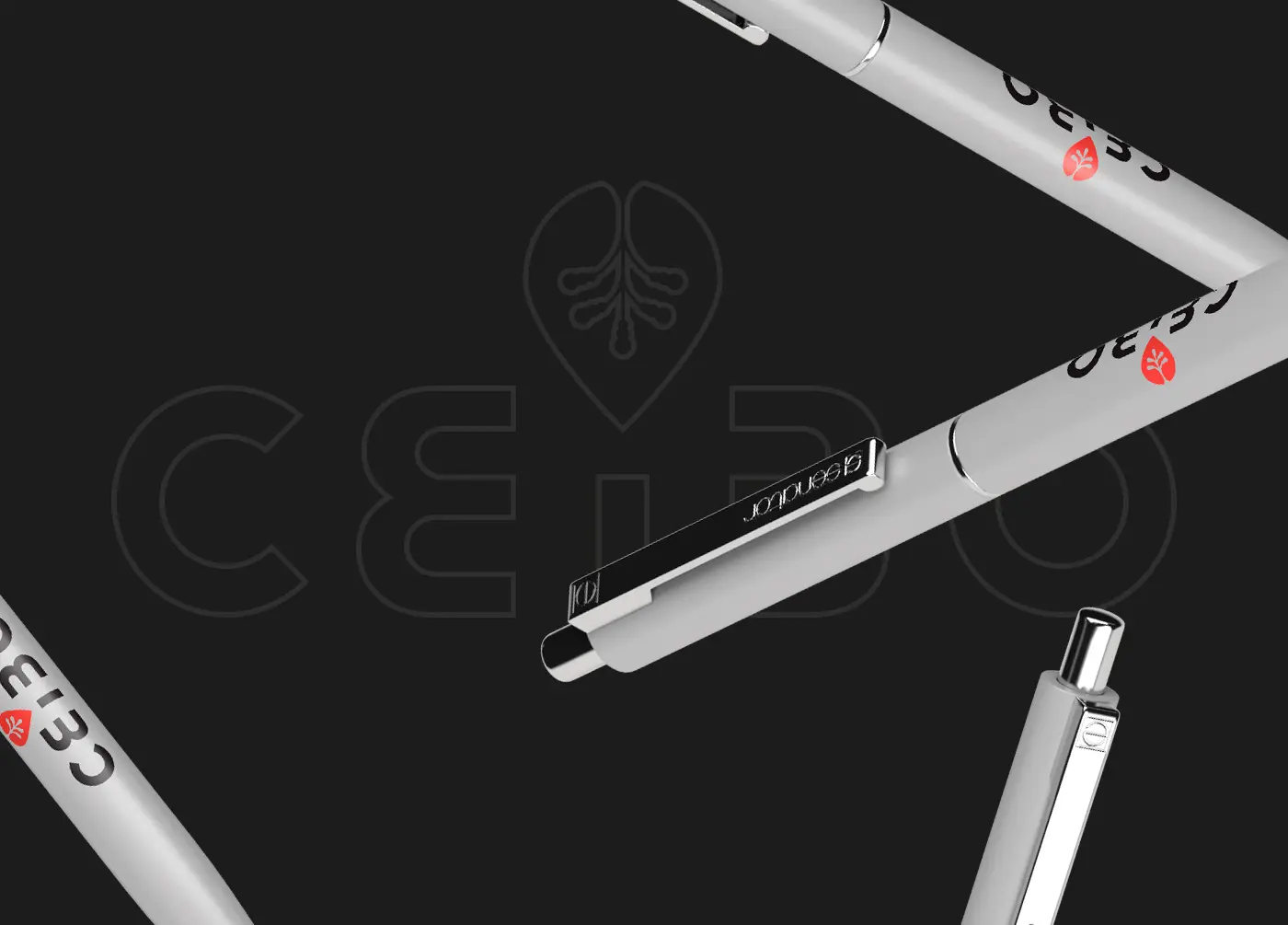 Pens engraved with the Ceibo Group logo, on a dark background