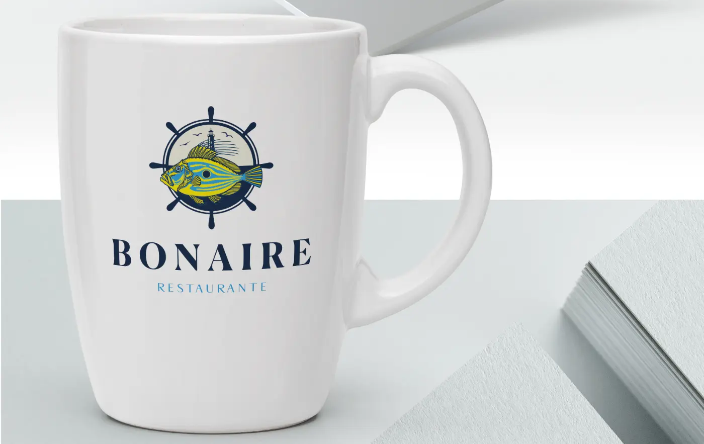 Mockup of a white mug with Bonaire Restaurante's fish and helm logotype