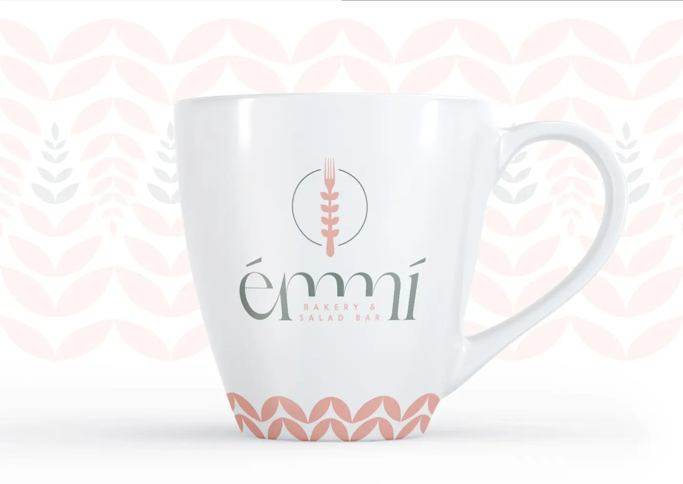 White ceramic mug with the Émmí logo and a wheat-stalk and leaf motif
