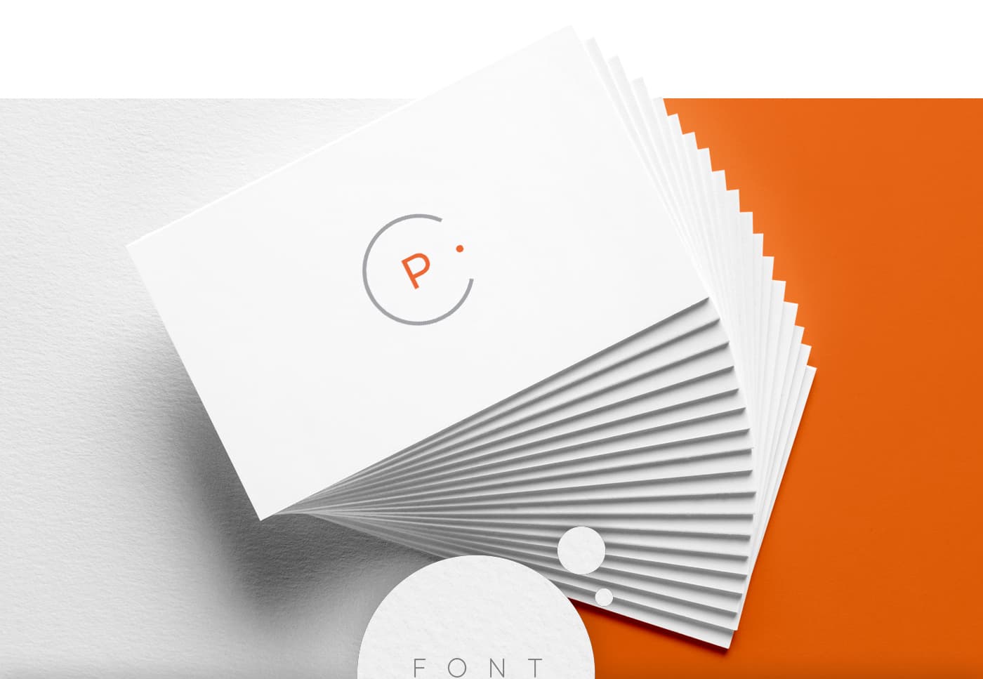 White business cards with the orange symbol on an orange background