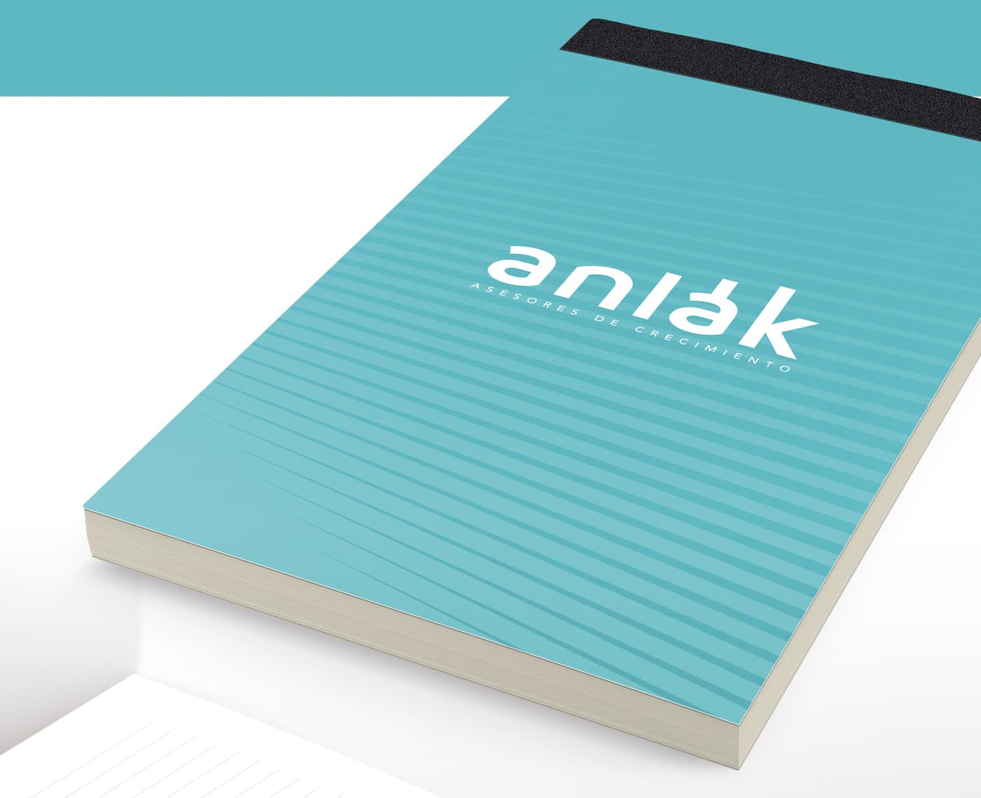 Mockup de libreta corporativa con el logotipo de Anlak en turquesa
