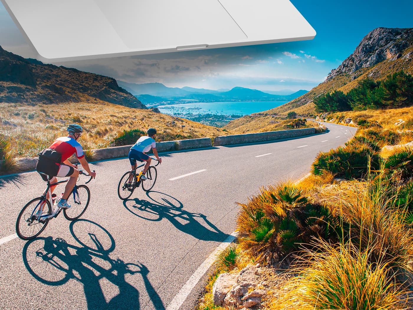 Photomontage of two cyclists on a mountain road next to the bay