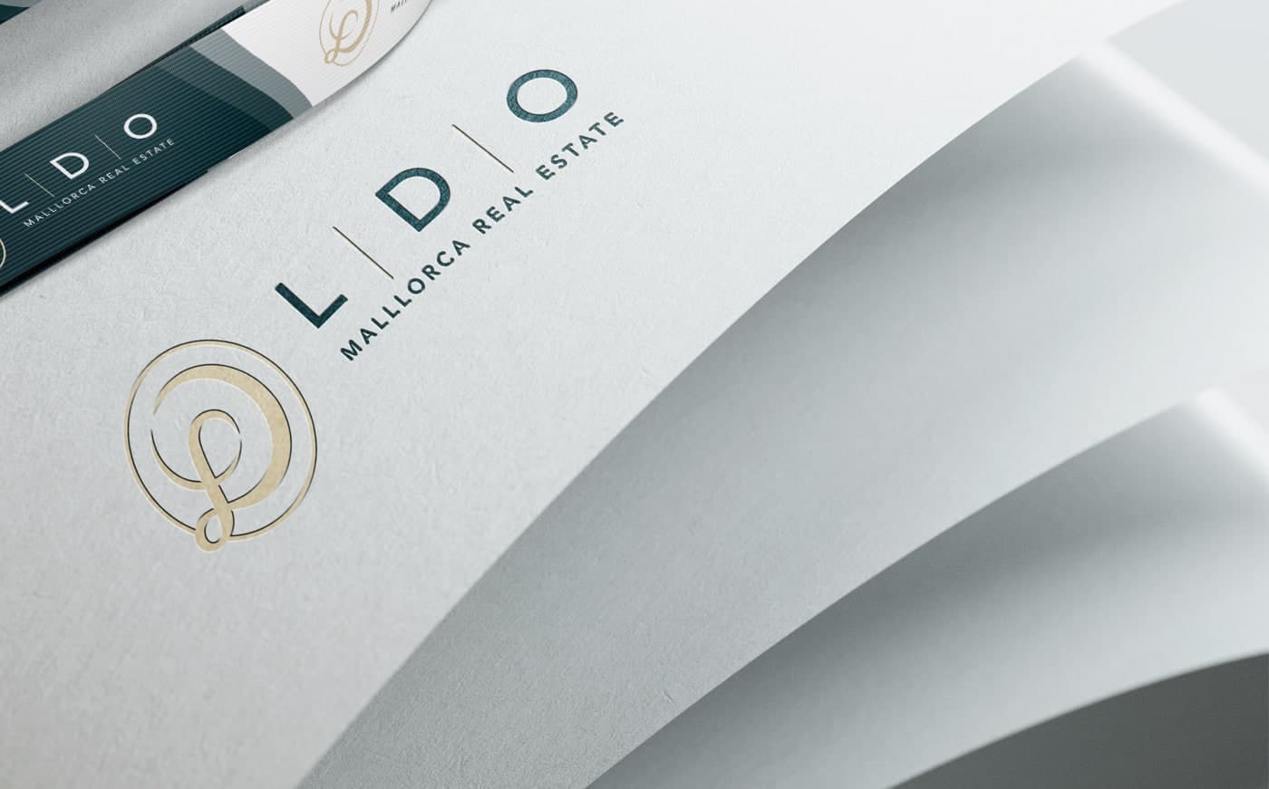 Embossed detail of the LDO logo on folded cream paper