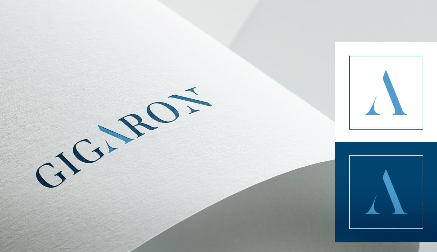 Logotip GIGARON gravat en relleu sobre paper i aplicacions del símbol en blau
