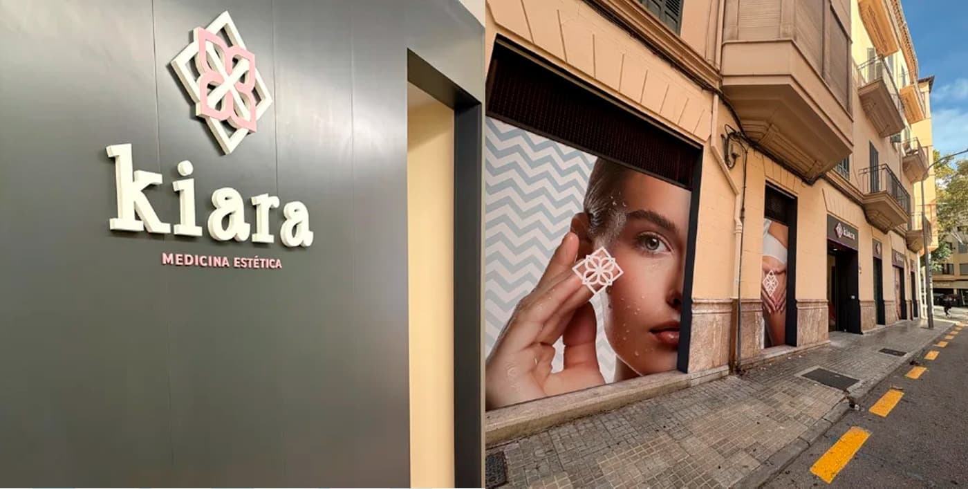 Three-dimensional sign on the façade and a vinyl with a woman's face in the shop window